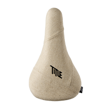 Beige bicycle seat with 'Title' logo on a white background