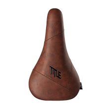 Brown bicycle seat with 'TITLE' branding on a white background