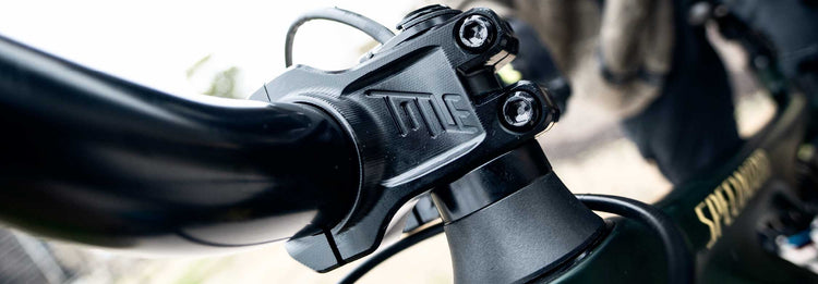 Close up of a mountain bike stem and handlebar on a blurred background