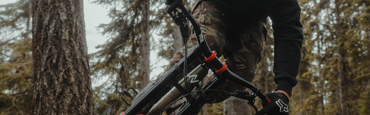 Person riding a mountain bike with TitleMTB components