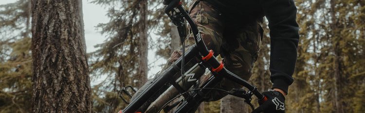 Person riding a mountain bike with TitleMTB components