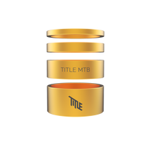 Gold metal components with 'TITLE MTB' branding on a white background