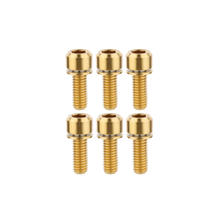 Set of six gold screws on a white background